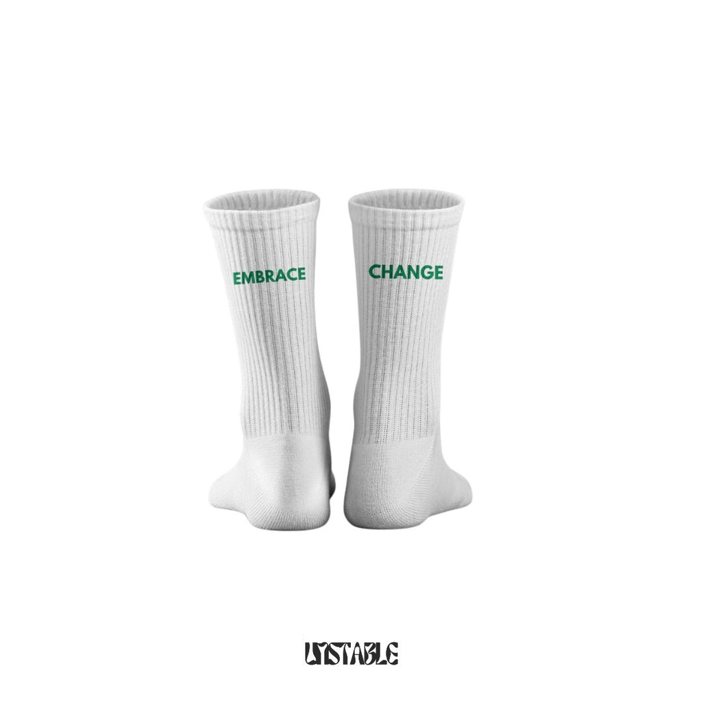 White socks with 'Embrace Change' text on a white background