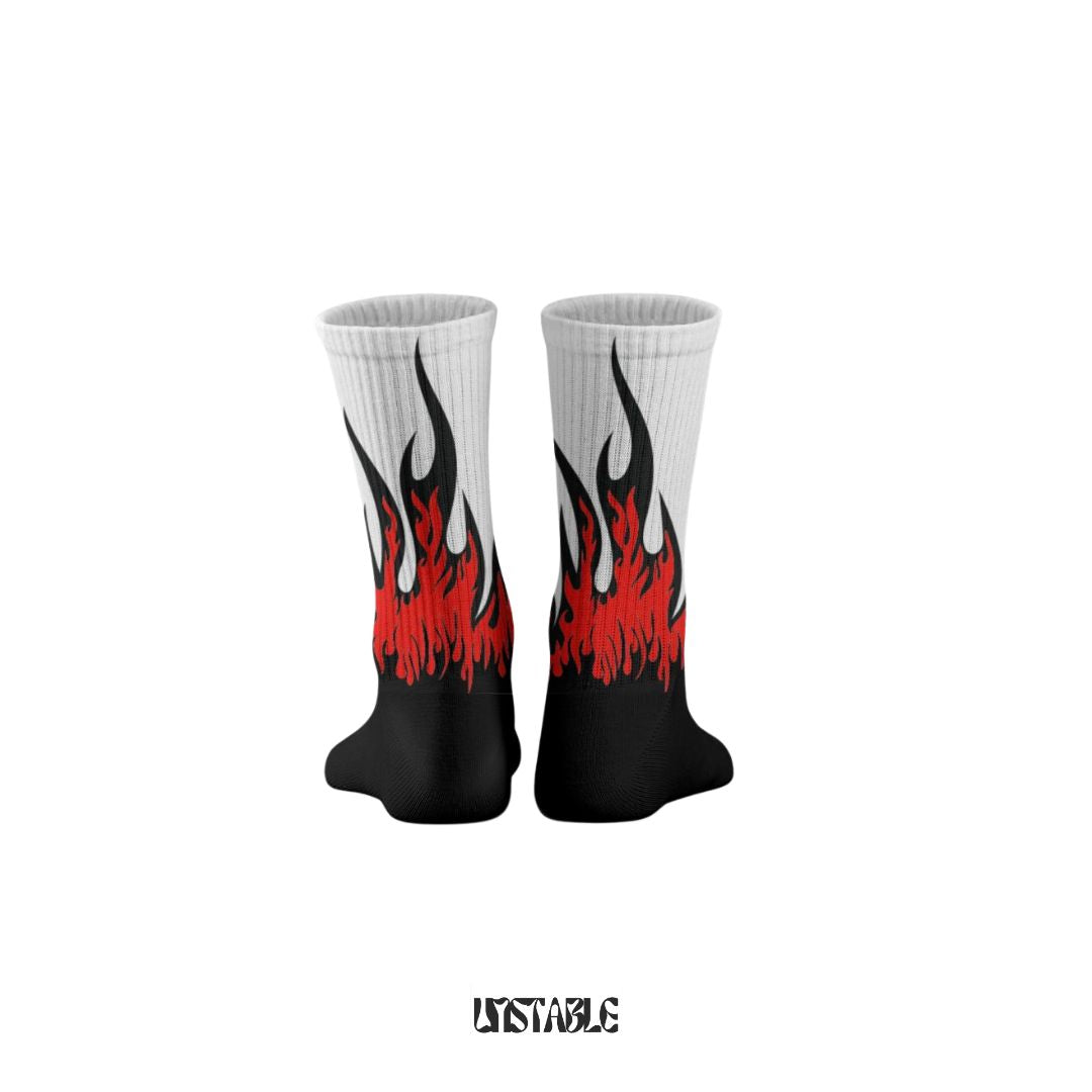 White socks with black and red flame design on a white background unstable better than sockscarving