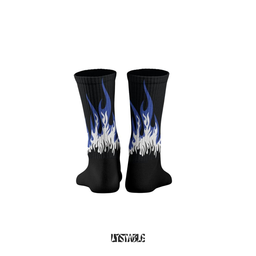 Black socks with blue and white flame design on a white background fire editions unstable better than sockscarving 