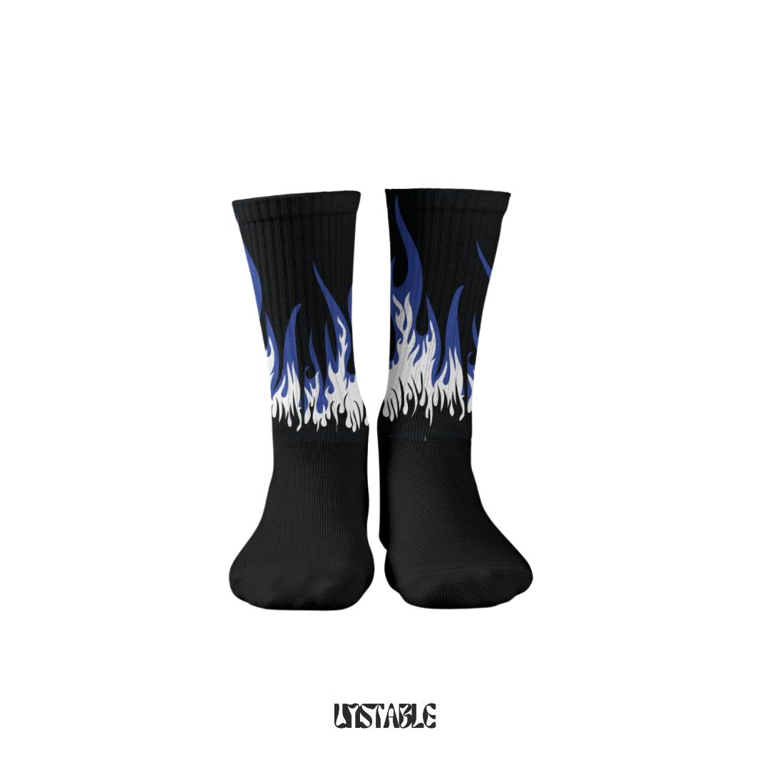 Black socks with blue and white flame design on a white background fire editions unstable better than sockscarving