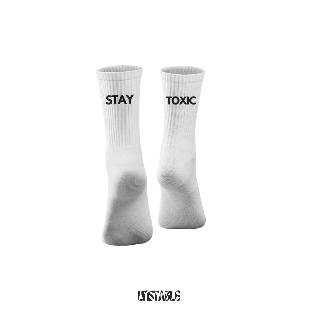 White socks with 'STAY TOXIC' text on a white background